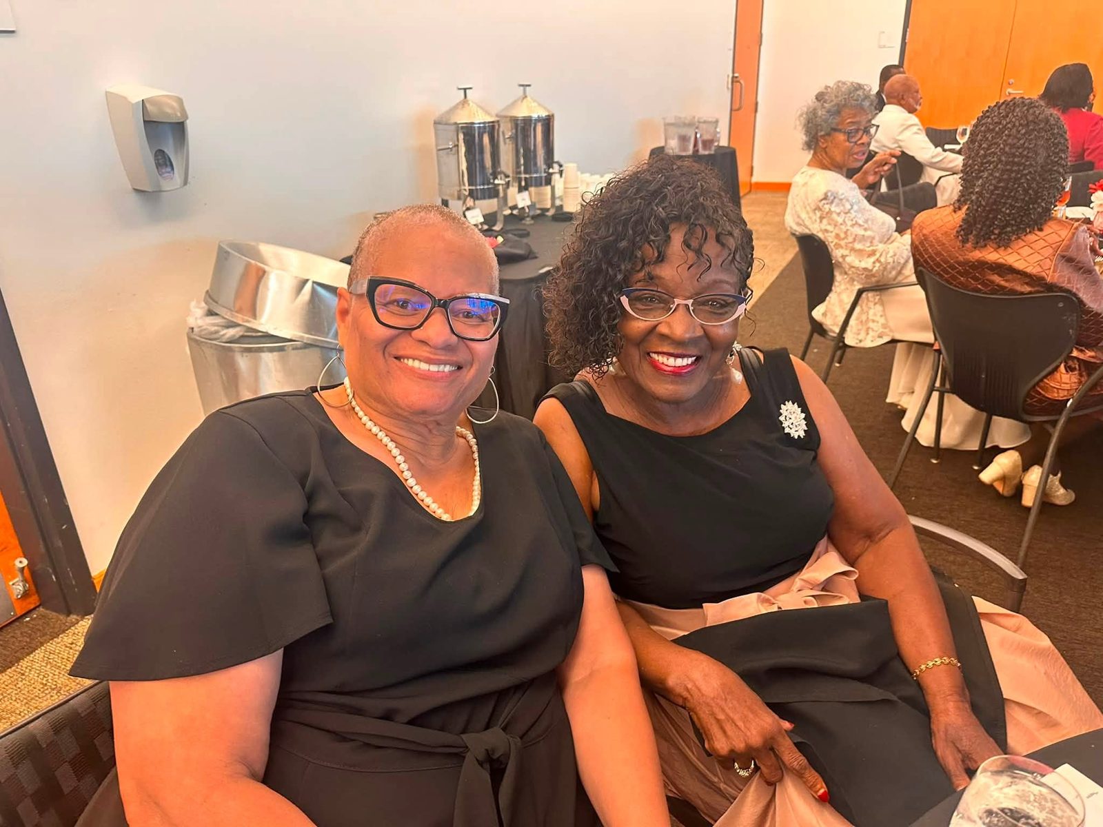 Two guests smiling together at the Grayson County NAACP Scholarship & Awards Banquet