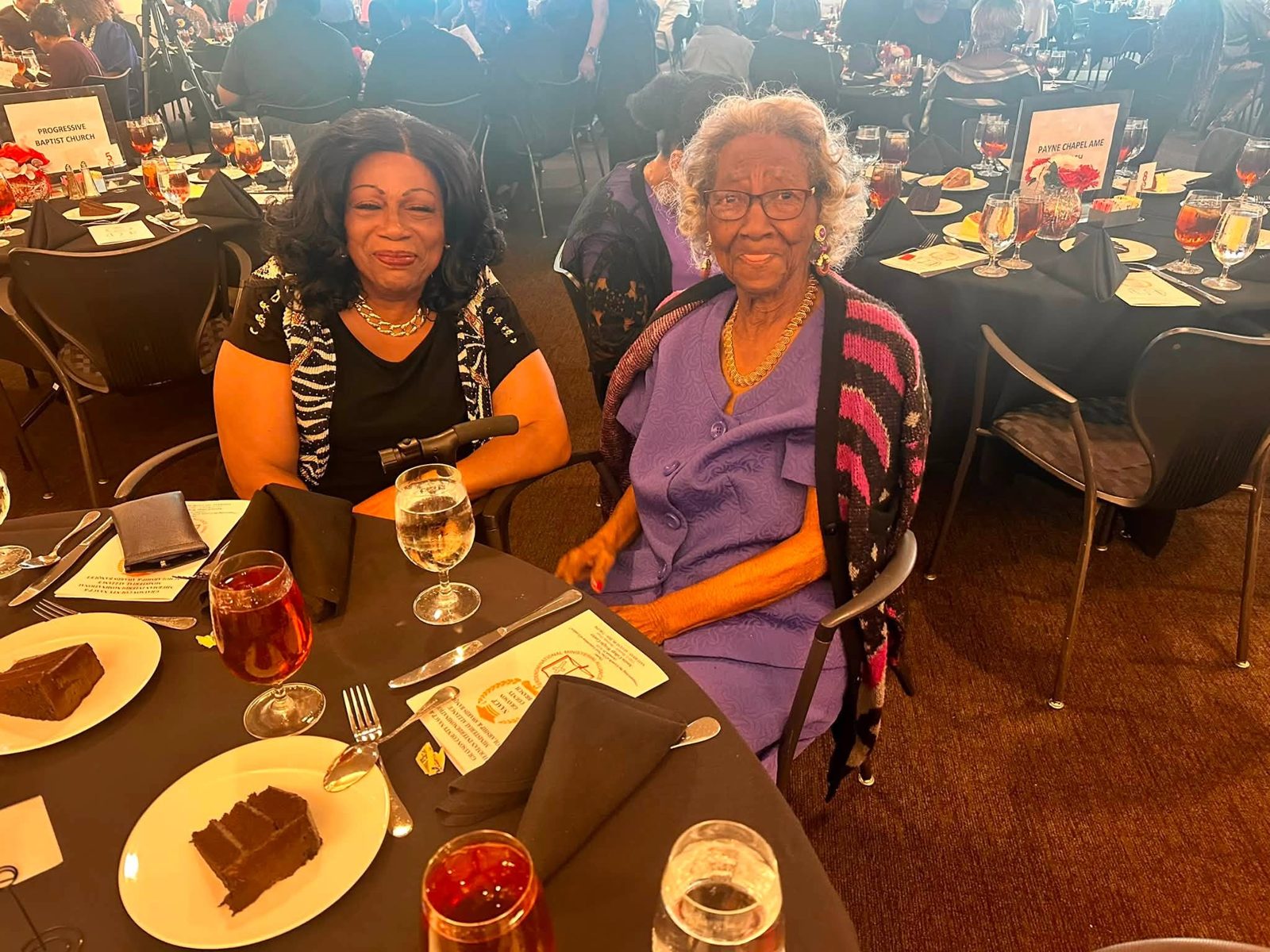 Two guests smiling at their table during the banquet program
