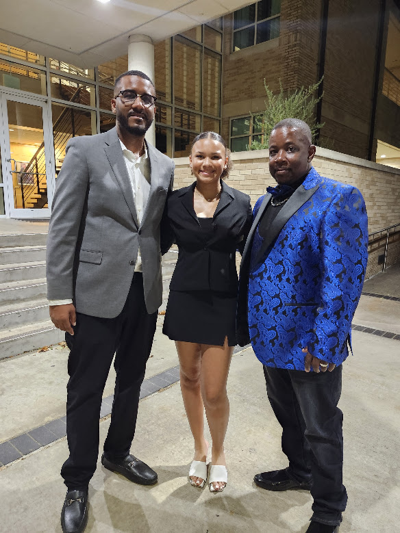 Three attendees posing outside Austin College after the banquet