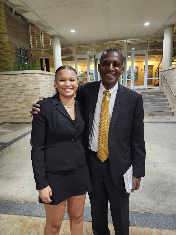 A scholarship recipient standing with a branch member outside the venue